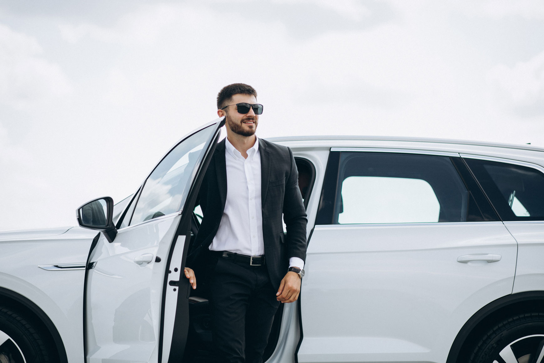 handsome business man by white car handsome business man by white car